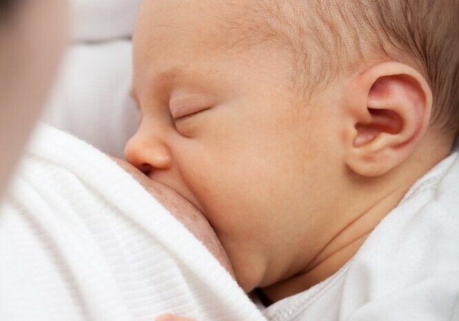 baby latching on mother